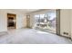 Spacious living room with large picture window and connection to the kitchen at 10731 Rosalie Dr, Northglenn, CO 80233