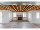 Unfinished basement featuring a fireplace, bare ceiling and multiple windows at 116 Willowleaf Dr, Littleton, CO 80127