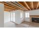 Unfinished basement with door to outside, bare ceiling and fireplace at 116 Willowleaf Dr, Littleton, CO 80127