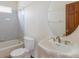 Cozy bathroom featuring a tub with a shower and a white pedestal sink at 116 Willowleaf Dr, Littleton, CO 80127