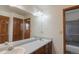Bathroom featuring double sinks, mirrors, and a shower at 116 Willowleaf Dr, Littleton, CO 80127