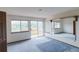 Bedroom with sliding glass doors to balcony deck, mountain views, mirror, and blue carpeting at 116 Willowleaf Dr, Littleton, CO 80127