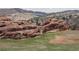 Landscape featuring large rock formations, open green fields, and distant houses at 116 Willowleaf Dr, Littleton, CO 80127