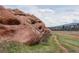 Rock formation and open green fields in neighborhood with homes in the background at 116 Willowleaf Dr, Littleton, CO 80127
