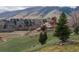 Picturesque landscape with rolling green hills, red rocks, and distant homes at 116 Willowleaf Dr, Littleton, CO 80127