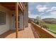 Spacious wood deck overlooking grassy area and picturesque natural rock formations in the distance at 116 Willowleaf Dr, Littleton, CO 80127