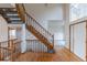 Entryway with hardwood flooring, stairs, and a view to a large window and the front door at 116 Willowleaf Dr, Littleton, CO 80127