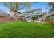 The spacious backyard features a lush lawn, garden features and a private patio at 1474 E Weldona Way, Superior, CO 80027