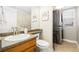 Compact bathroom featuring vanity, toilet, and stacked washer and dryer at 1474 E Weldona Way, Superior, CO 80027