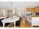 Open concept dining area, kitchen and entry way with wood floors and neutral paint at 1474 E Weldona Way, Superior, CO 80027