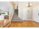 Open entryway and staircase with hardwood floors and a view into the living room at 1474 E Weldona Way, Superior, CO 80027