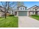 Charming two-story home with a well-manicured lawn and a two-car garage is bathed in sunlight at 1474 E Weldona Way, Superior, CO 80027