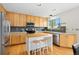 Modern kitchen featuring stainless steel appliances, light wood cabinets, and a functional island with seating at 1474 E Weldona Way, Superior, CO 80027