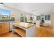 Open kitchen and dining area with wood floors, center island and backyard access at 1474 E Weldona Way, Superior, CO 80027