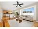 Open concept living area with hardwood floors, large windows, and seamless flow to the kitchen at 1474 E Weldona Way, Superior, CO 80027