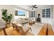 Cozy living room boasts hardwood floors, a large window, built-in shelves and a stylish ceiling fan at 1474 E Weldona Way, Superior, CO 80027