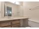 Bright bathroom with a large mirror, single sink, and white toilet at 5138 S Sedalia Ct, Centennial, CO 80015