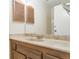 Bathroom featuring a single sink vanity with a large mirror and wooden accents at 5138 S Sedalia Ct, Centennial, CO 80015