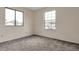 Bright bedroom with neutral carpet and two windows providing natural light at 5138 S Sedalia Ct, Centennial, CO 80015