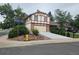 Exterior view of a two story home with manicured landscaping and a spacious driveway on a corner lot at 5138 S Sedalia Ct, Centennial, CO 80015