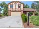 Traditional home with a large driveway, brick accents, trimmed bushes, and a welcoming mailbox at 5138 S Sedalia Ct, Centennial, CO 80015