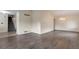 Open-concept living area with hardwood flooring and elegant chandelier lighting, adjacent to the staircase at 5138 S Sedalia Ct, Centennial, CO 80015