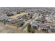 An aerial view showcases a quiet residential neighborhood with well-maintained homes, tree-lined streets, and green spaces at 11594 Yellow Daisy Dr, Parker, CO 80134
