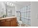 Cozy bathroom with single sink, wood cabinets, toilet, shower, and tiled floors at 11594 Yellow Daisy Dr, Parker, CO 80134