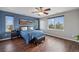 Serene bedroom with hardwood floors, blue accent wall, natural light, and an inviting atmosphere at 11594 Yellow Daisy Dr, Parker, CO 80134