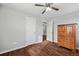 Bright bedroom features hardwood floors, ceiling fan, and ensuite bathroom access at 11594 Yellow Daisy Dr, Parker, CO 80134