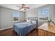 Cozy bedroom featuring wood floors, natural light from two windows, and neutral wall colors at 11594 Yellow Daisy Dr, Parker, CO 80134