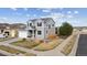 Well-maintained home with a manicured lawn, two-car garage, neutral gray paint, and classic blue shutters at 11594 Yellow Daisy Dr, Parker, CO 80134
