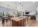 Modern kitchen with a large island, stainless steel appliances, and an adjacent dining area, perfect for gatherings at 11594 Yellow Daisy Dr, Parker, CO 80134