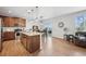 Spacious kitchen featuring an island, pendant lighting, modern appliances, and an adjacent dining area at 11594 Yellow Daisy Dr, Parker, CO 80134