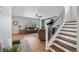 Inviting living room with hardwood floors, a large window, and a staircase, filled with natural light at 11594 Yellow Daisy Dr, Parker, CO 80134