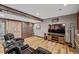 Home theater area featuring a large flat screen TV, wooden barn doors, and leather recliners at 11594 Yellow Daisy Dr, Parker, CO 80134