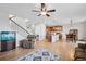 Open-concept living space seamlessly connecting the living room, kitchen, and dining area with hardwood floors at 11594 Yellow Daisy Dr, Parker, CO 80134