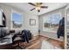Well-lit office space with wood floors, two windows, and ceiling fan for a productive work environment at 11594 Yellow Daisy Dr, Parker, CO 80134