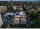Aerial view of a condominium building with parking and the city in the background at 740 N Pearl St # 606, Denver, CO 80203