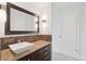 Bathroom vanity with a stone countertop, modern sink, and stylish fixtures at 740 N Pearl St # 606, Denver, CO 80203