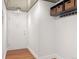 Foyer featuring hardwood floors, a hanging rack, and overhead storage baskets at 740 N Pearl St # 606, Denver, CO 80203