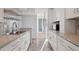 Galley kitchen featuring neutral countertops, stainless steel appliances, and ample cabinet space at 740 N Pearl St # 606, Denver, CO 80203