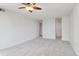 Living room featuring carpeted floors, a ceiling fan, and convenient access to other rooms at 740 N Pearl St # 606, Denver, CO 80203