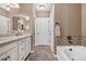 Elegant bathroom with double vanity and a soaking tub at 2198 Primo Rd # 103, Highlands Ranch, CO 80129