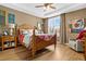 Bright bedroom with hardwood floors and a wooden bed frame at 2198 Primo Rd # 103, Highlands Ranch, CO 80129