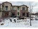 Exterior view of a two-story townhome with stone accents and landscaping at 2198 Primo Rd # 103, Highlands Ranch, CO 80129