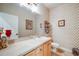 Powder room with patterned wallpaper, neutral countertops, and decorative artwork at 22428 Quail Run Ln, Parker, CO 80138