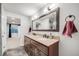 Bathroom with double sink vanity with granite countertops, modern fixtures, and tile flooring at 22428 Quail Run Ln, Parker, CO 80138