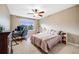 Bedroom featuring ceiling fan, large window, and desk perfect for a home office at 22428 Quail Run Ln, Parker, CO 80138