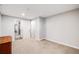 Empty bedroom with neutral carpeting, closet and bathroom access, and natural light at 22428 Quail Run Ln, Parker, CO 80138